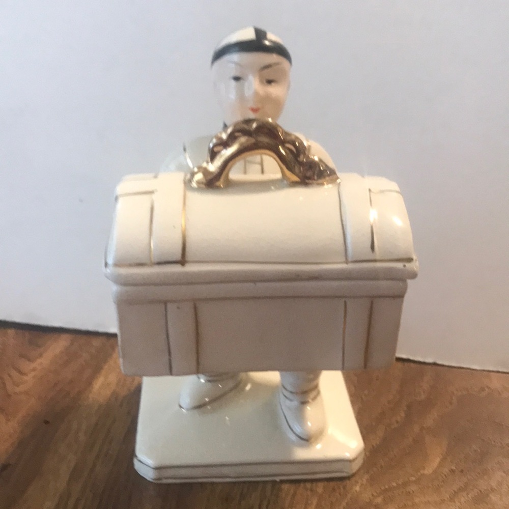 Porcelian Oriental man bringing treasures in golden chest